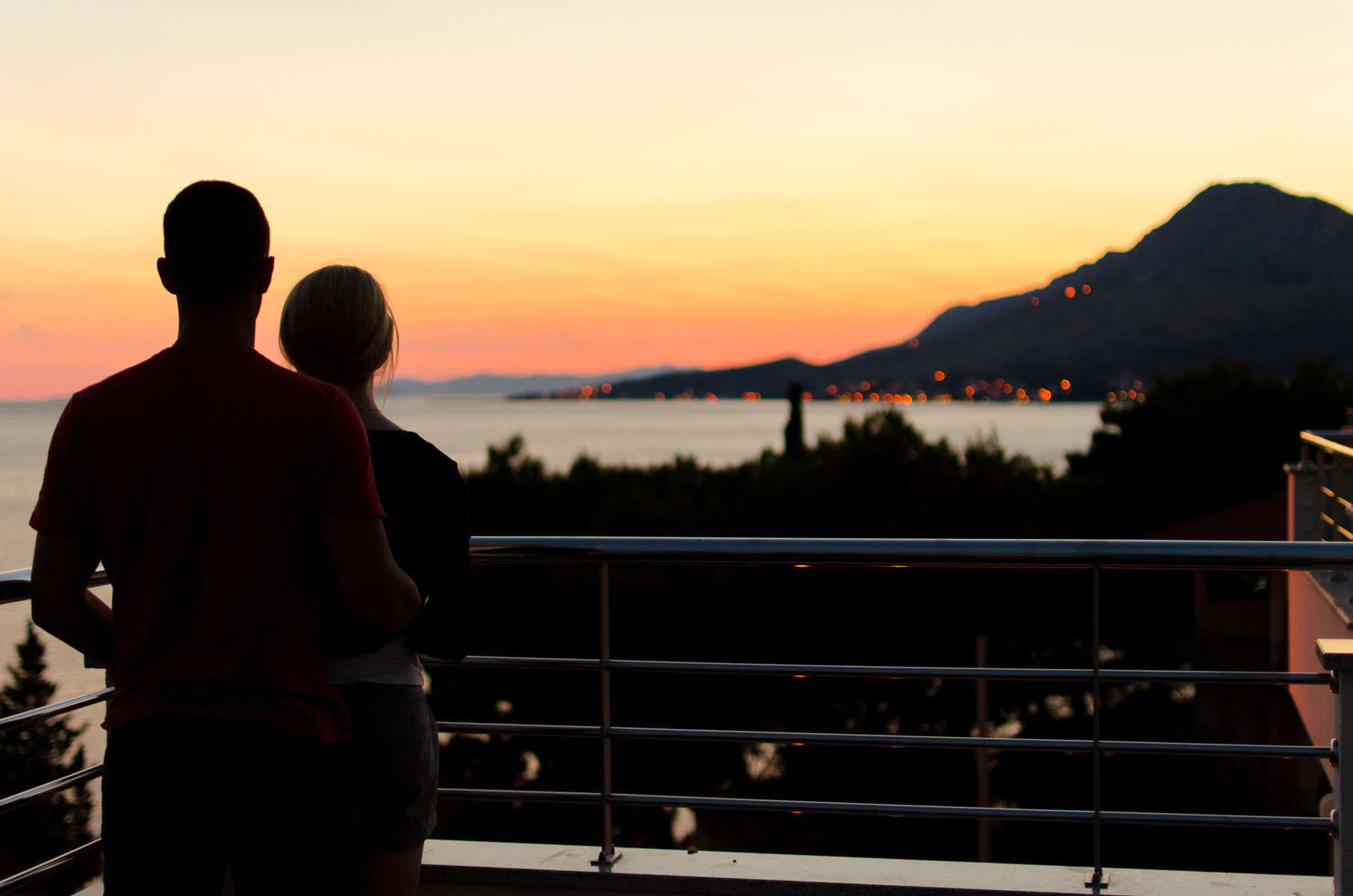 Couple stood on their balcony - KMJ family lawyers in London