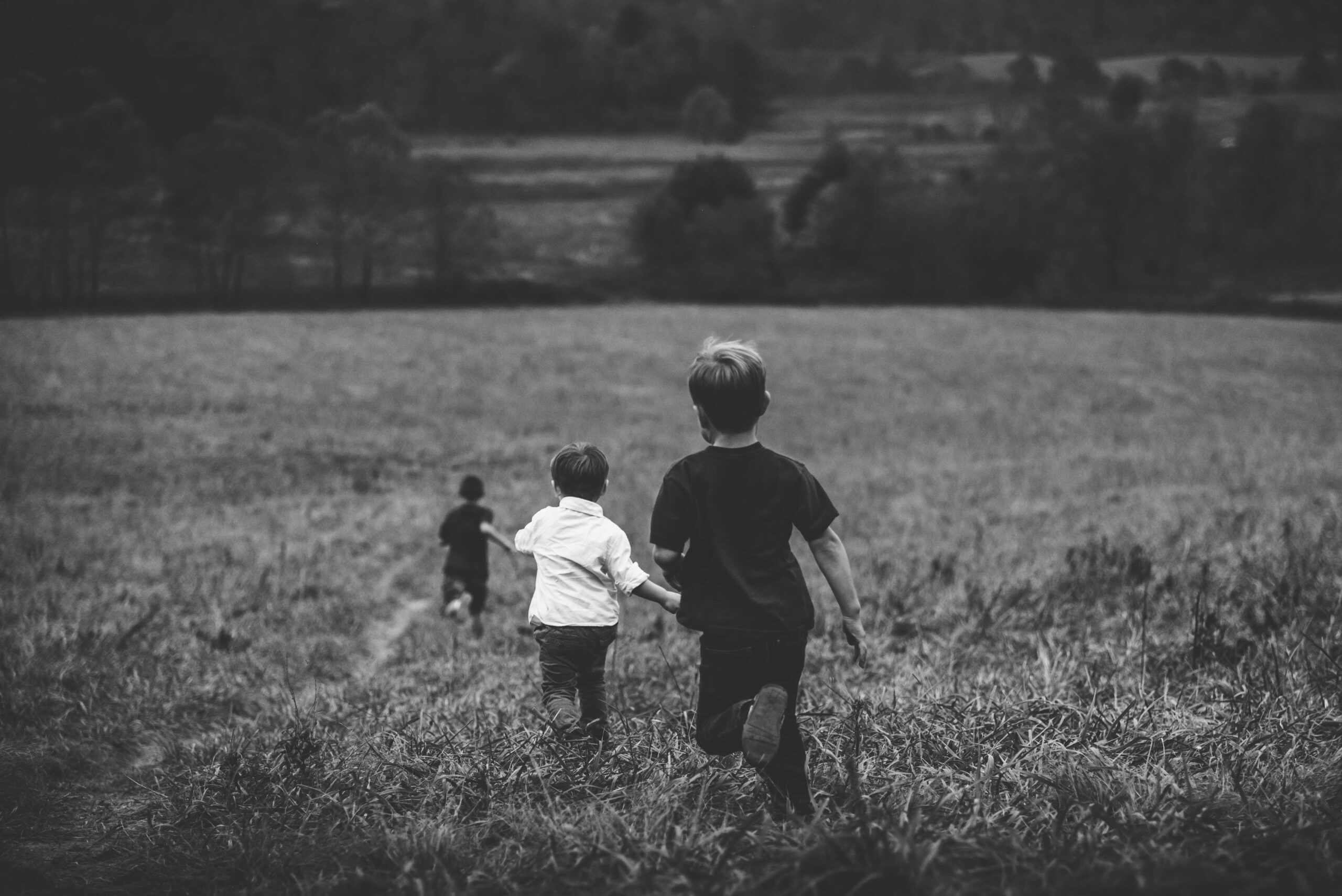 Children running in a field - KMJ family law solicitors in london
