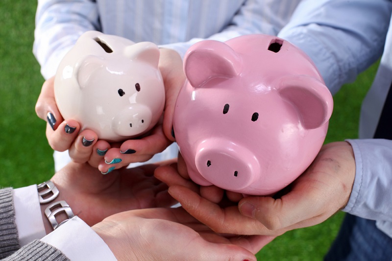 Family hands holding piggy banks - symbolising the law around inheritance and divorce
