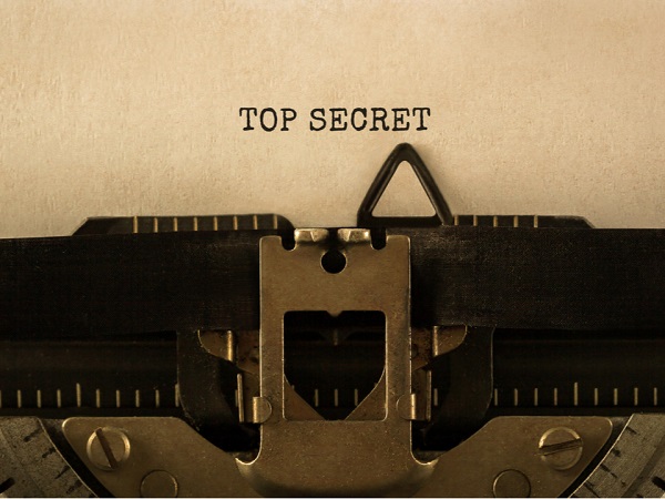 top secret written on a brown file in typewriter text symbolic of planning a divorce secretly.